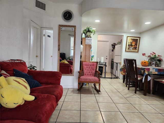 living room with light tile patterned floors, recessed lighting, and visible vents