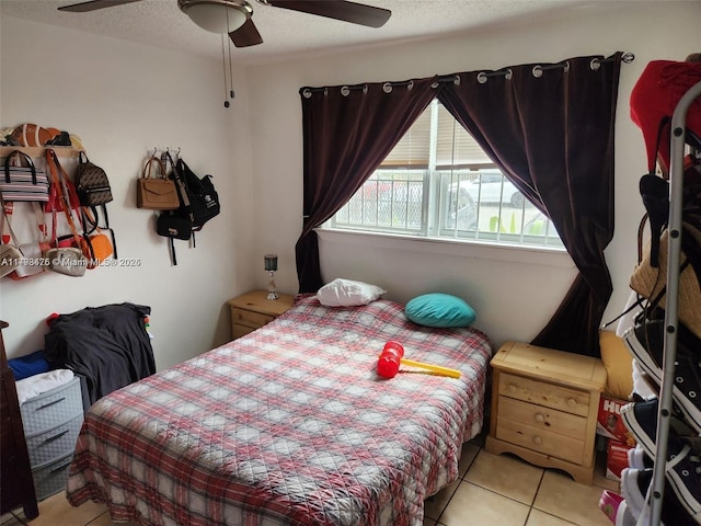 tiled bedroom with a ceiling fan
