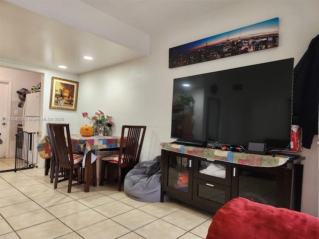 tiled dining room featuring recessed lighting