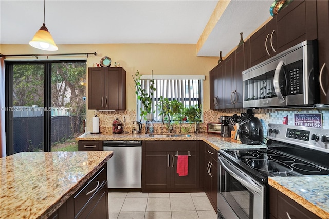kitchen featuring a sink, appliances with stainless steel finishes, tasteful backsplash, and a wealth of natural light
