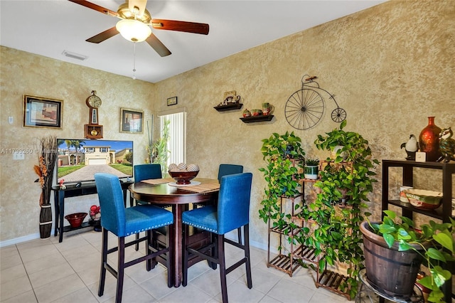 dining space with baseboards, ceiling fan, tile patterned flooring, and visible vents
