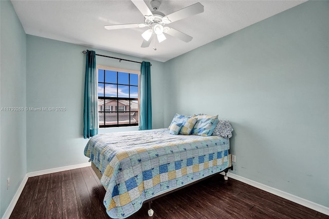 bedroom featuring baseboards, ceiling fan, and wood finished floors