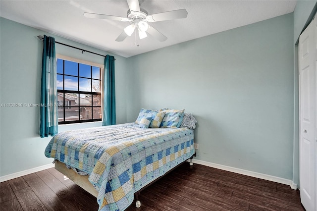 bedroom featuring baseboards, ceiling fan, and wood finished floors