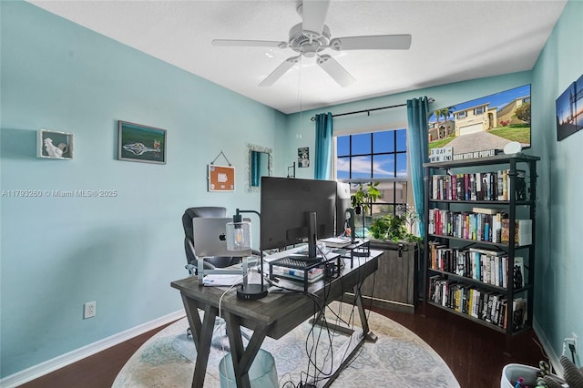 office space with baseboards, a ceiling fan, and wood finished floors