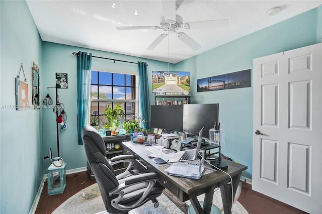 office area featuring baseboards, a ceiling fan, and wood finished floors