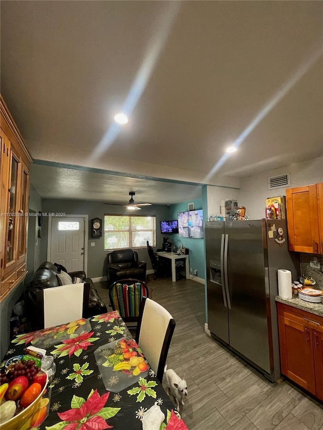 2144 NW 85th St, Miami, FL 33147 - dining room featuring a ceiling fan, baseboards, visible vents, and light wood-style floors