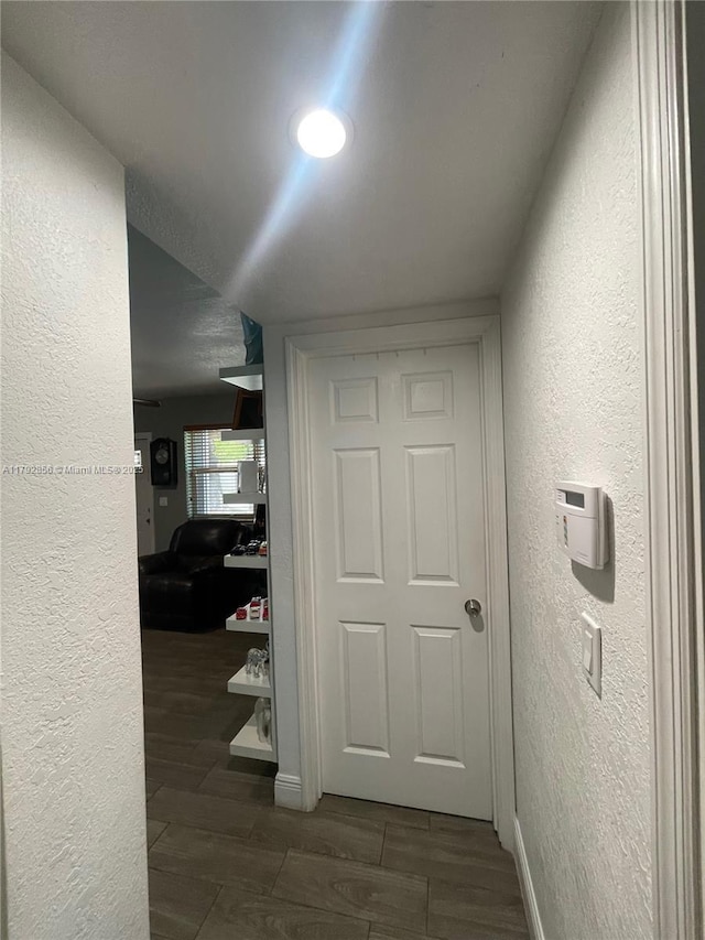 2144 NW 85th St, Miami, FL 33147 - hall featuring a textured wall, baseboards, and wood tiled floor