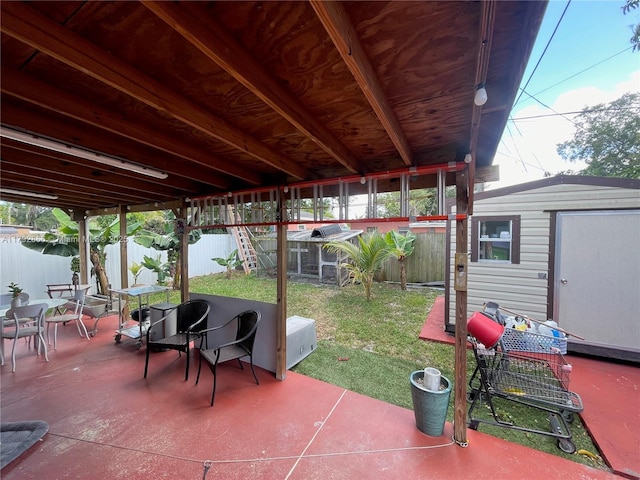 2144 NW 85th St, Miami, FL 33147 - view of patio with a fenced backyard, an outbuilding, and a storage shed