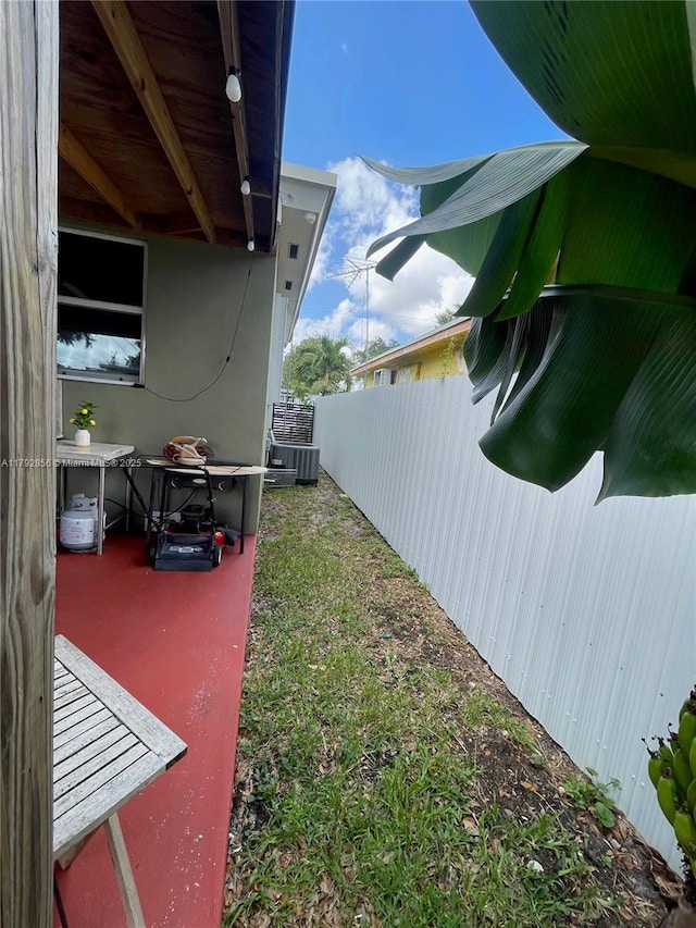 2144 NW 85th St, Miami, FL 33147 - view of yard featuring central AC and fence
