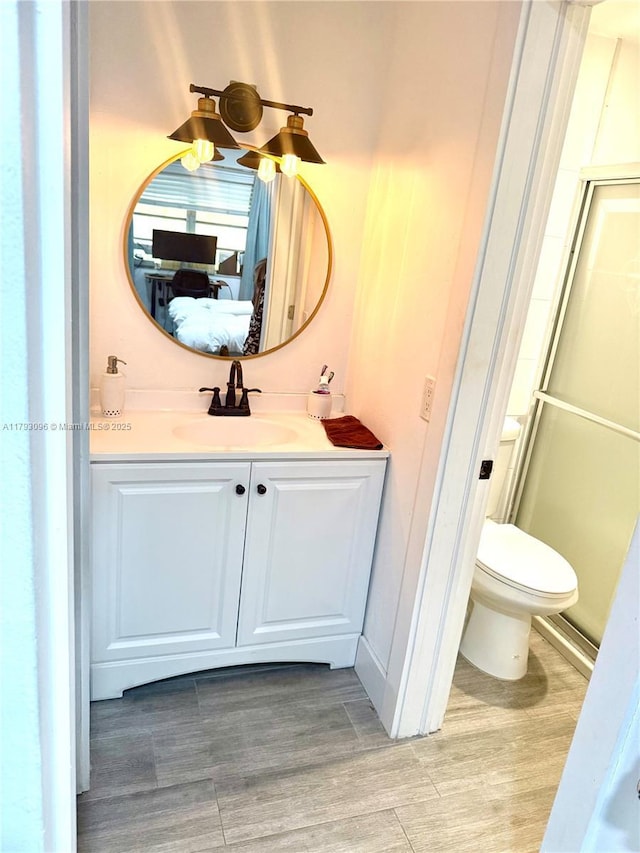 bathroom with toilet, ensuite bathroom, and vanity