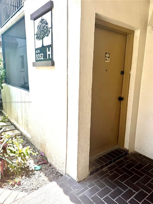 doorway to property with stucco siding