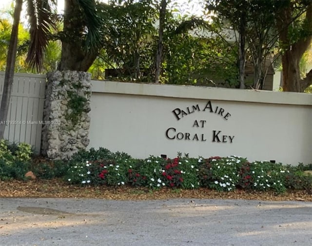 community / neighborhood sign with fence