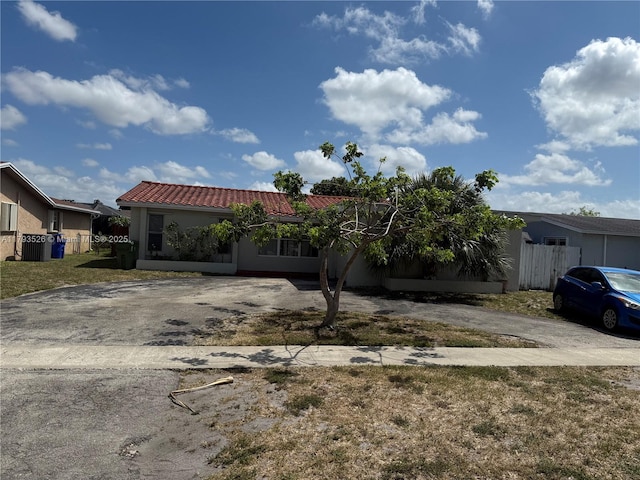 8940 Johnson St, Pembroke Pines, FL 33024 - view of front of house with stucco siding, fence, driveway, and a tile roof