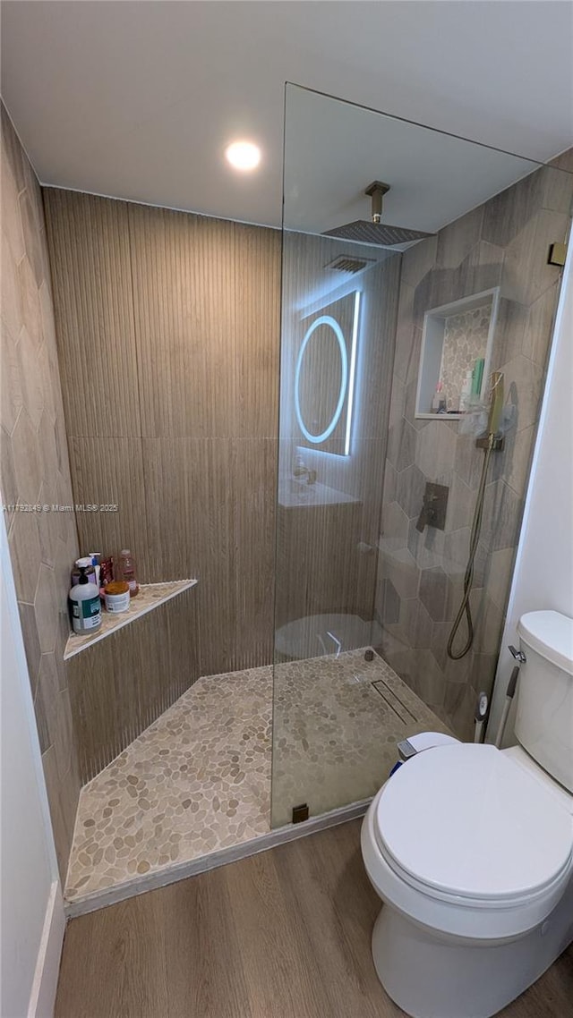 full bathroom featuring toilet, walk in shower, and wood finished floors