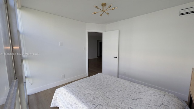 bedroom featuring visible vents, baseboards, and wood finished floors