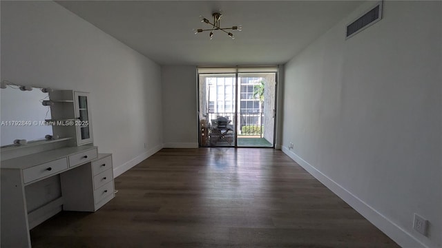 unfurnished dining area with visible vents, dark wood finished floors, baseboards, and a wall of windows