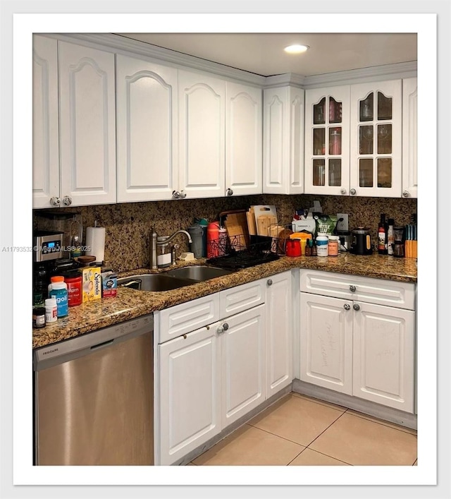 5825 Collins Ave Unit Ph1B, Miami Beach, FL 33140 - kitchen with stainless steel dishwasher, a sink, light tile patterned floors, and white cabinets