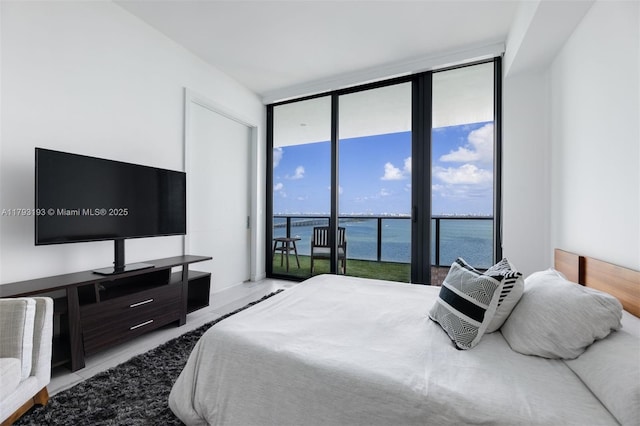 bedroom featuring access to outside and floor to ceiling windows