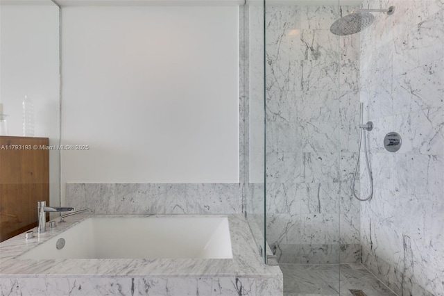 bathroom featuring a marble finish shower and a garden tub