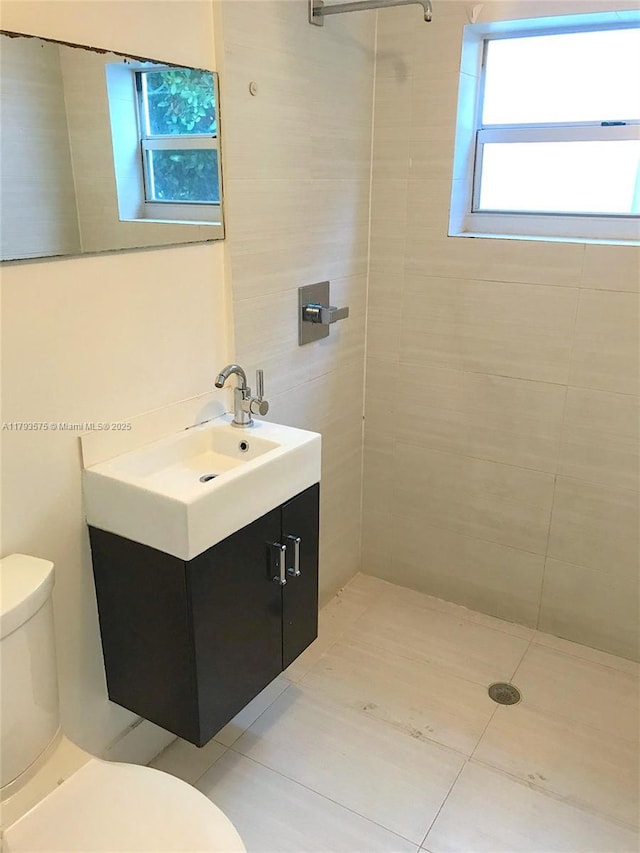 1604 Drexel Ave Unit 107, Miami Beach, FL 33139 - bathroom with vanity, tile patterned flooring, toilet, and tiled shower