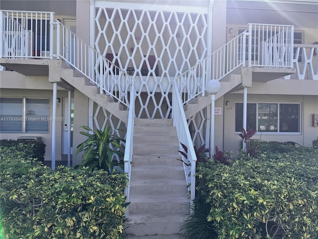 view of home's exterior featuring stairs and stucco siding