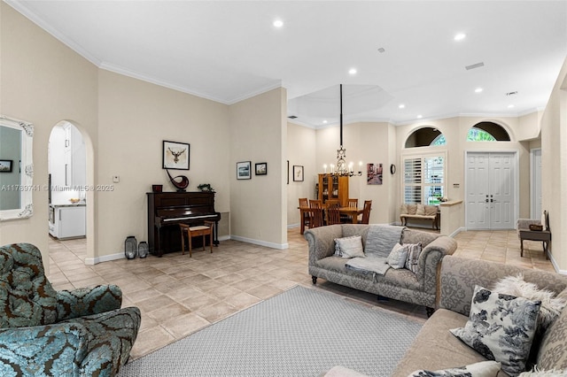 living area featuring light tile patterned floors, arched walkways, ornamental molding, and recessed lighting
