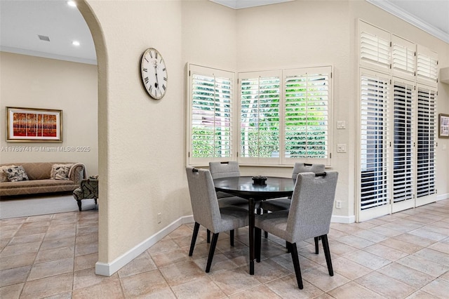 dining area with crown molding, baseboards, recessed lighting, arched walkways, and light tile patterned floors