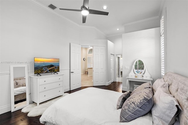 bedroom with crown molding, baseboards, wood finished floors, and visible vents