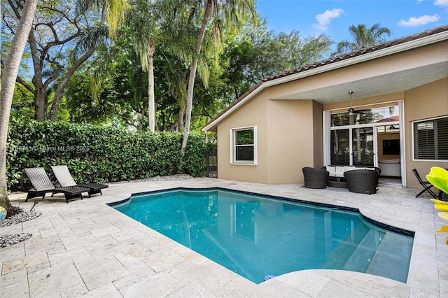 view of swimming pool with a fenced backyard, a fenced in pool, an outdoor hangout area, and a patio area