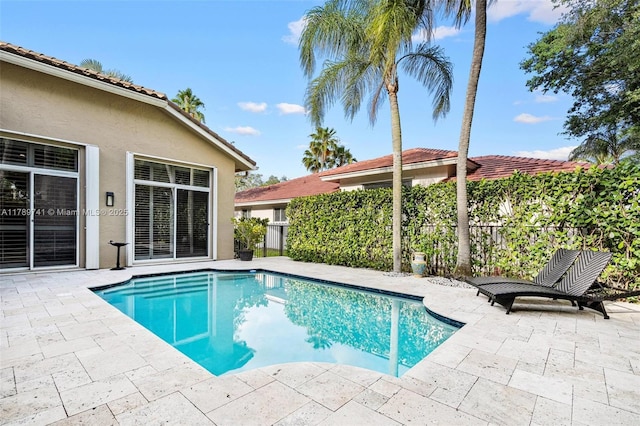 view of pool with a patio, fence, and a fenced in pool