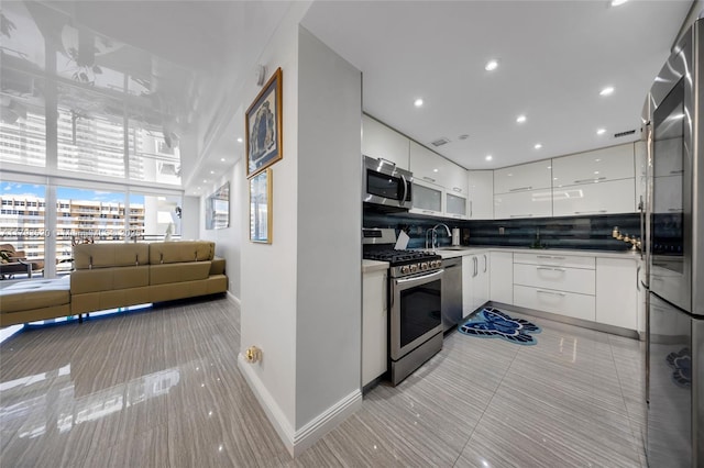 2030 S Ocean Dr Unit 2005, Hallandale Beach, FL 33009 - kitchen featuring white cabinetry, baseboards, appliances with stainless steel finishes, and modern cabinets