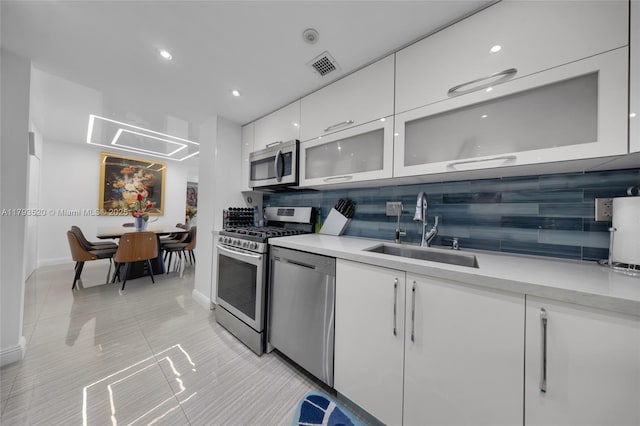 2030 S Ocean Dr Unit 2005, Hallandale Beach, FL 33009 - kitchen with visible vents, a sink, light countertops, stainless steel appliances, and white cabinetry