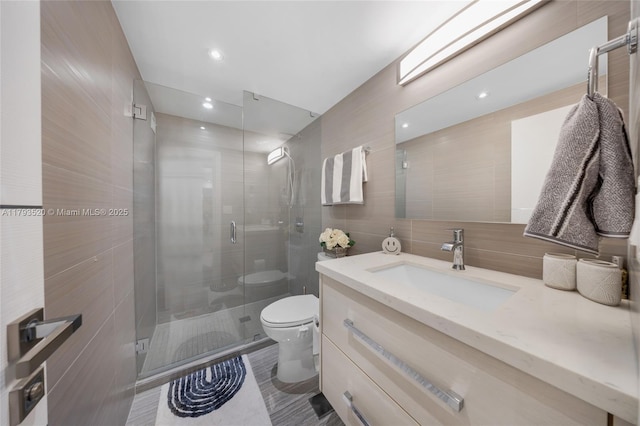 2030 S Ocean Dr Unit 2005, Hallandale Beach, FL 33009 - full bathroom featuring tile walls, a stall shower, vanity, and toilet