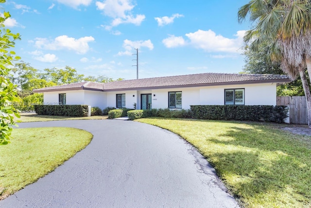 14405 SW 84th Ct, Palmetto Bay, FL 33158 - ranch-style home featuring fence, a front lawn, stucco siding, curved driveway, and a tiled roof