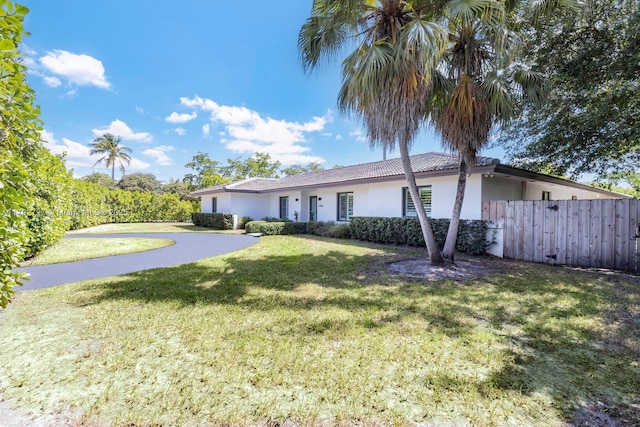 14405 SW 84th Ct, Palmetto Bay, FL 33158 - view of front of home featuring stucco siding, fence, and a front yard
