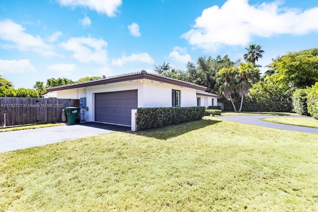14405 SW 84th Ct, Palmetto Bay, FL 33158 - view of property exterior featuring a garage, fence, aphalt driveway, a yard, and stucco siding