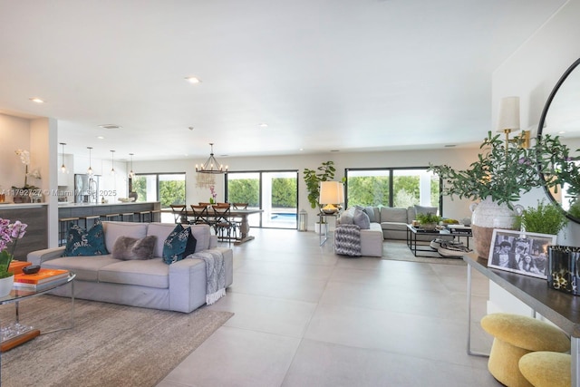 14405 SW 84th Ct, Palmetto Bay, FL 33158 - living room featuring recessed lighting, a wealth of natural light, and an inviting chandelier