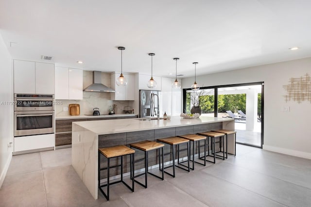 14405 SW 84th Ct, Palmetto Bay, FL 33158 - kitchen with visible vents, modern cabinets, wall chimney range hood, white cabinetry, and a large island with sink