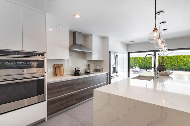 14405 SW 84th Ct, Palmetto Bay, FL 33158 - kitchen with a healthy amount of sunlight, modern cabinets, wall chimney range hood, a sink, and stainless steel appliances