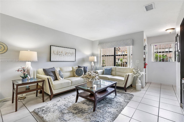 living room featuring visible vents and light tile patterned floors