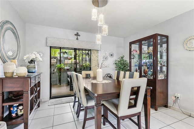 dining room featuring light tile patterned floors and baseboards