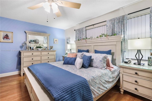 bedroom featuring baseboards, ceiling fan, and wood finished floors