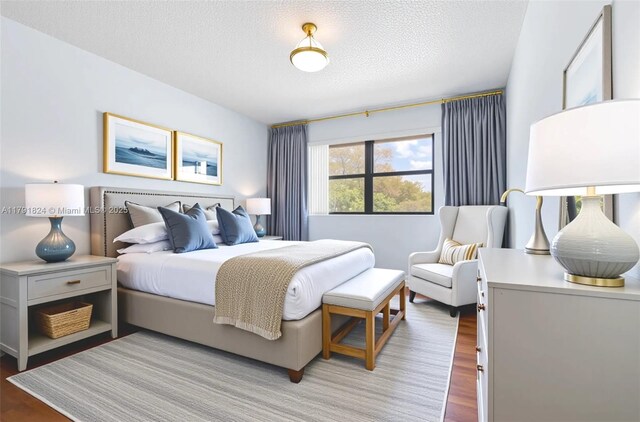 15520 SW 80th St Unit B-301, Miami, FL 33193 - bedroom featuring light wood-type flooring and a textured ceiling
