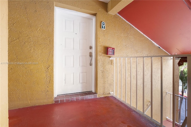 entrance to property with stucco siding