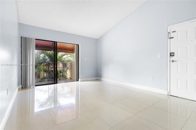 15520 SW 80th St Unit B-301, Miami, FL 33193 - unfurnished room with vaulted ceiling, baseboards, and tile patterned floors