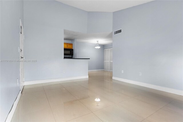 15520 SW 80th St Unit B-301, Miami, FL 33193 - empty room with light tile patterned floors and high vaulted ceiling