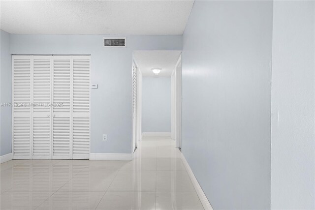 15520 SW 80th St Unit B-301, Miami, FL 33193 - hallway with tile patterned flooring and a textured ceiling