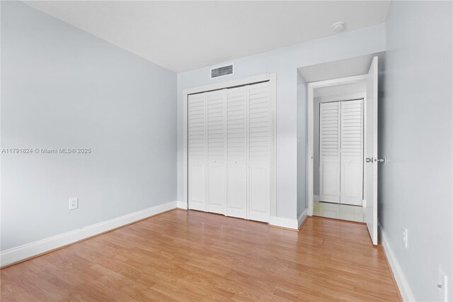 15520 SW 80th St Unit B-301, Miami, FL 33193 - unfurnished bedroom with light wood-style floors, baseboards, and a closet