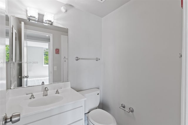 bathroom with toilet and vanity