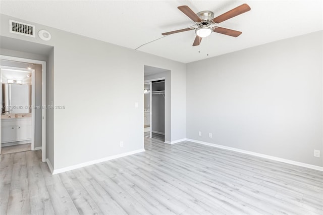unfurnished bedroom featuring a closet, baseboards, visible vents, and light wood-style floors